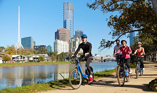 People on bikes beside the Yarra River in Melbourne.